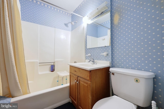 bathroom featuring toilet, wallpapered walls, shower / bath combo with shower curtain, and vanity