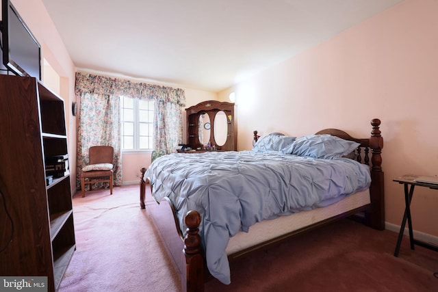 bedroom with carpet floors and baseboards