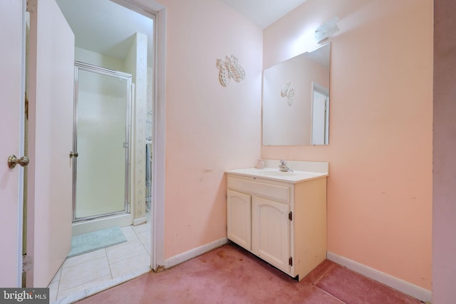 bathroom featuring carpet, baseboards, a shower stall, and vanity