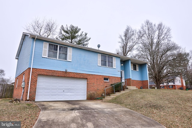 view of front of home featuring a front yard, concrete driveway, brick siding, and an attached garage