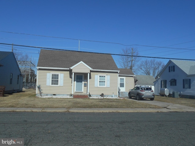 view of front facade with central AC unit and a front lawn