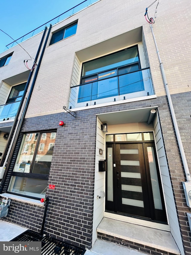 property entrance with brick siding