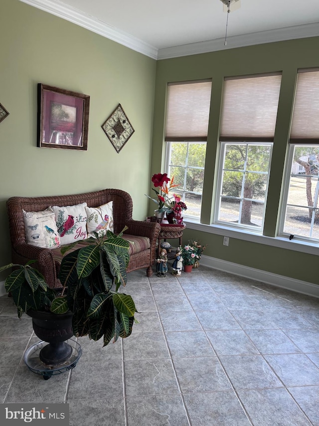 living room featuring a wealth of natural light, crown molding, and baseboards