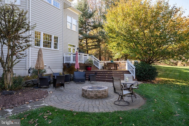 view of patio featuring an outdoor fire pit, a deck, and stairs