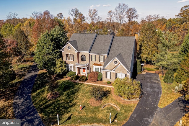 view of front of house featuring driveway and a chimney