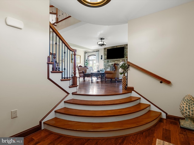 stairway featuring baseboards and wood finished floors