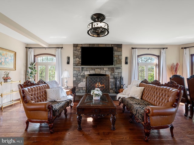 living area with hardwood / wood-style flooring and a fireplace