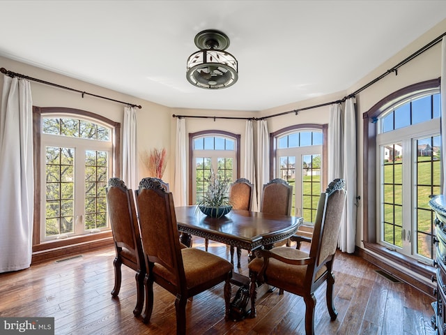 dining space featuring wood-type flooring and visible vents