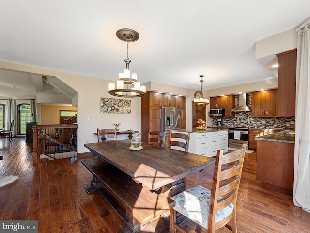 dining room featuring dark wood-style flooring and a notable chandelier
