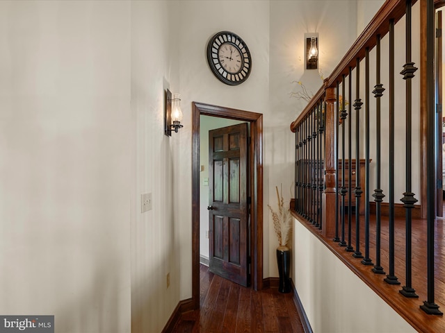 corridor with baseboards and hardwood / wood-style floors