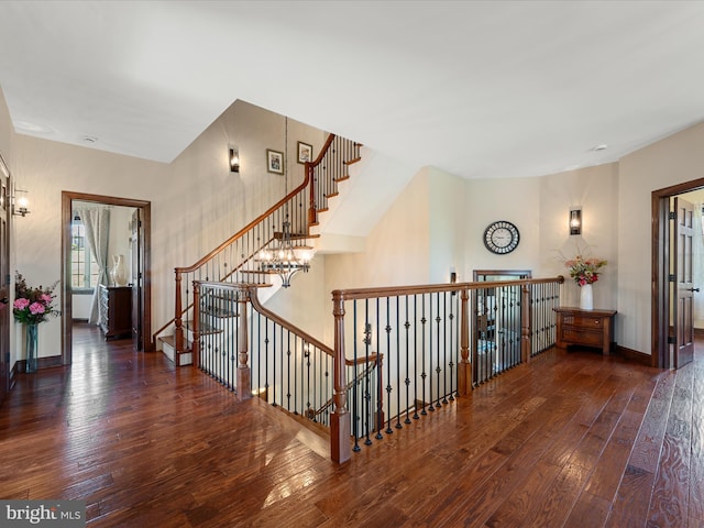staircase with baseboards and hardwood / wood-style flooring