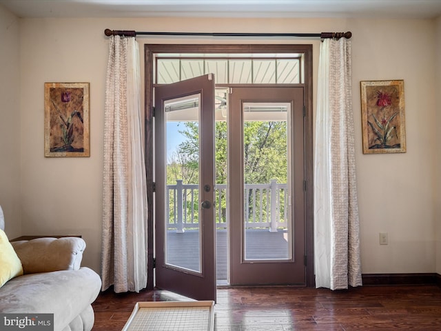 entryway featuring baseboards and wood finished floors