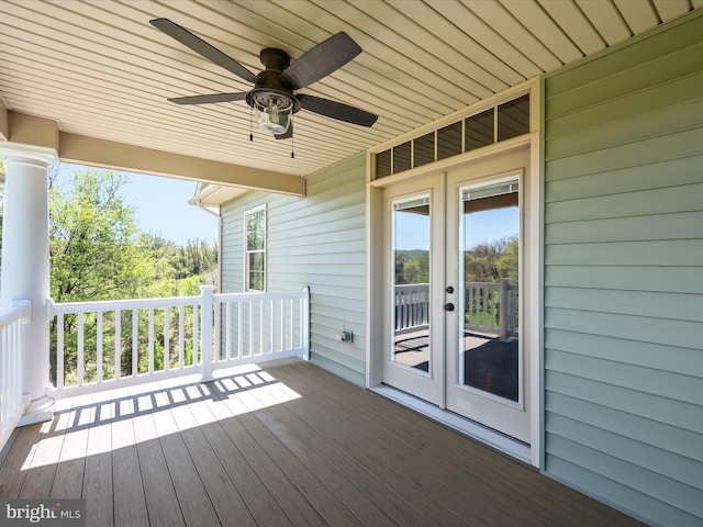 deck with french doors and a ceiling fan