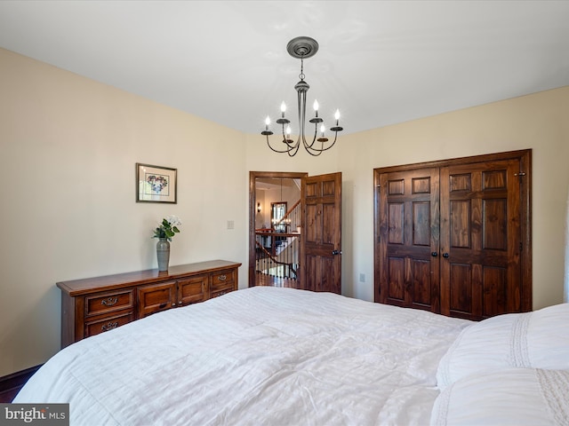 bedroom featuring an inviting chandelier and a closet
