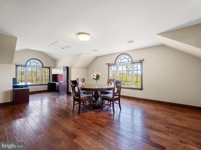 dining area featuring attic access, visible vents, dark wood finished floors, baseboards, and lofted ceiling