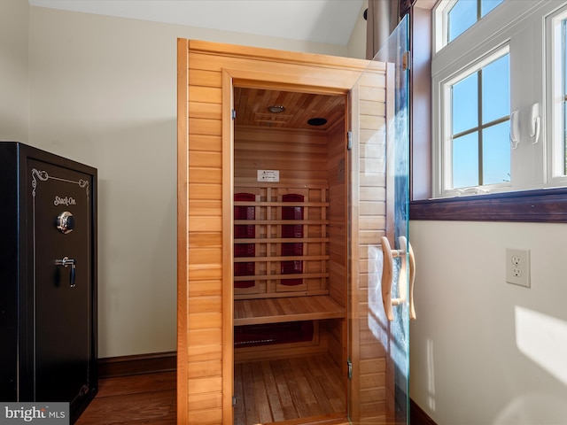 view of sauna / steam room with wood-type flooring and baseboards