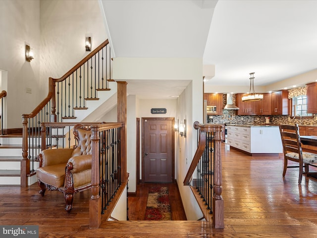 entryway featuring dark wood finished floors and stairway