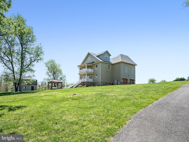 exterior space with a gazebo and a front yard