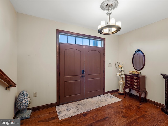 entryway with baseboards, dark wood finished floors, and a chandelier