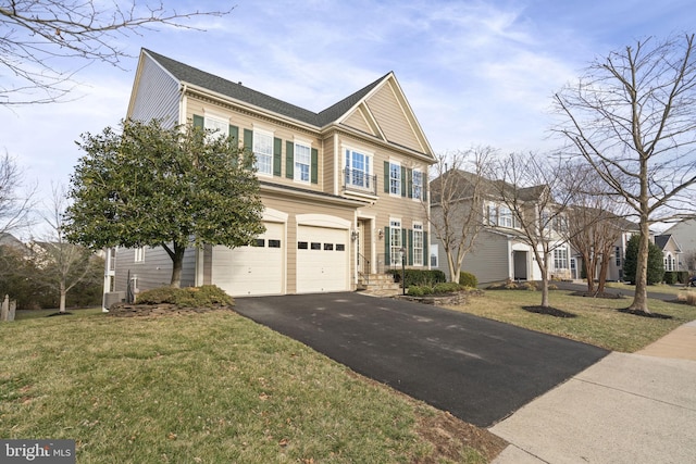 view of front of property featuring aphalt driveway, a front lawn, and a garage