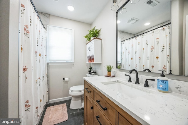 bathroom featuring toilet, tile patterned flooring, and vanity