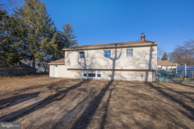 rear view of property featuring a yard