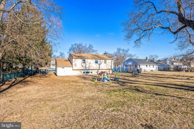 rear view of house with a lawn