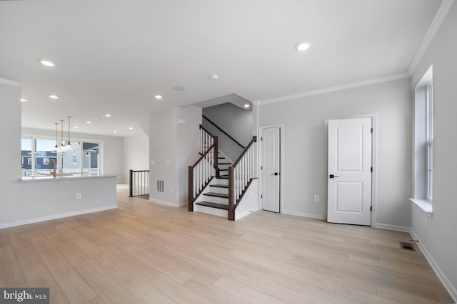 unfurnished room with light wood-type flooring and ornamental molding