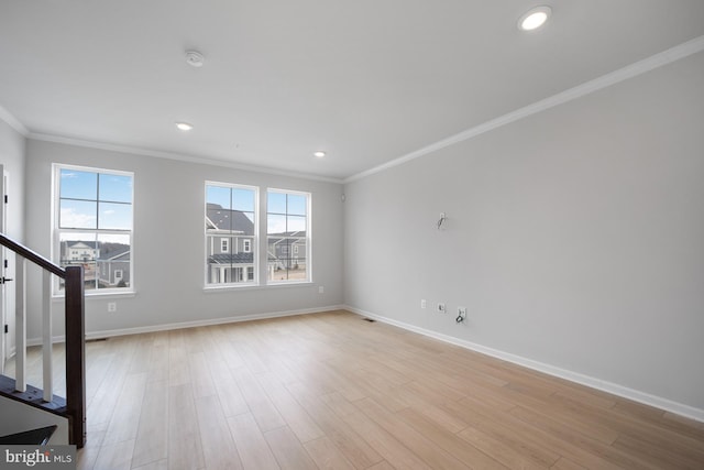 unfurnished living room with light wood-type flooring, plenty of natural light, and crown molding