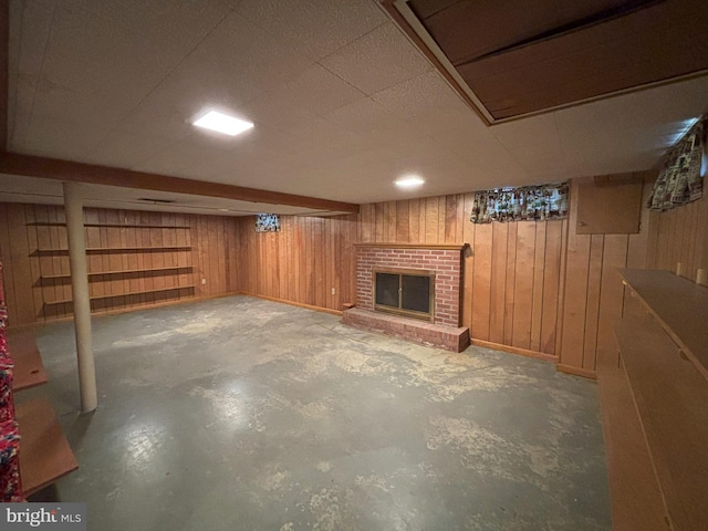 finished below grade area featuring wooden walls and a fireplace