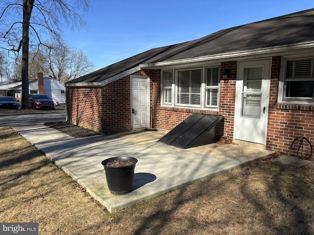 exterior space featuring brick siding