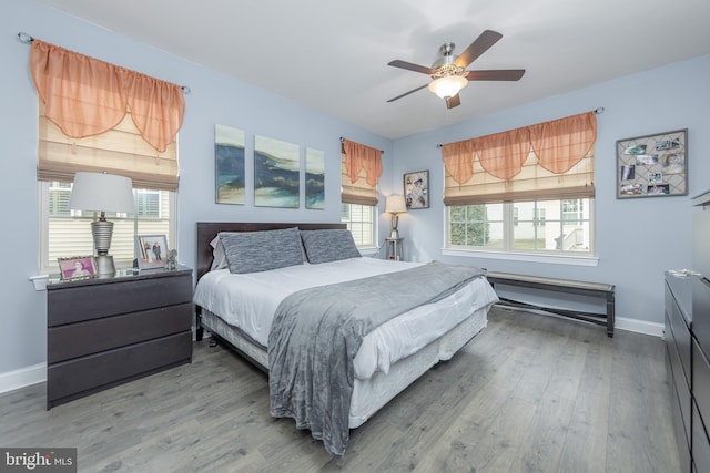 bedroom featuring ceiling fan, wood finished floors, and baseboards