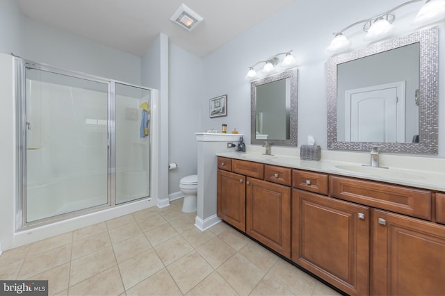 bathroom with tile patterned flooring, a sink, a shower stall, and toilet