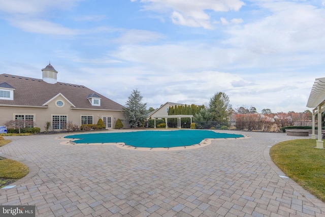 view of pool featuring a fenced in pool, a pergola, and a patio