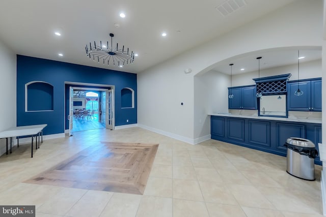 interior space featuring recessed lighting, visible vents, light countertops, blue cabinetry, and decorative light fixtures