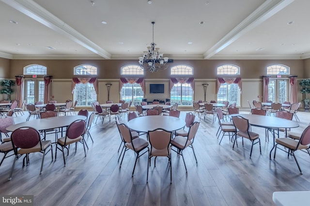 dining space featuring ornamental molding, plenty of natural light, and wood finished floors