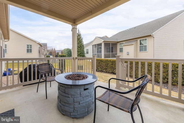 view of patio with a residential view and a fire pit