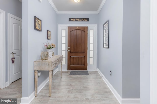 foyer entrance with a healthy amount of sunlight, light wood-type flooring, and ornamental molding