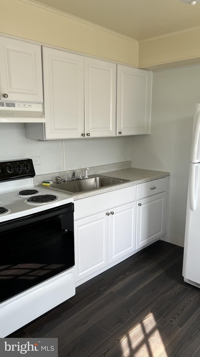 kitchen featuring dark wood-style flooring, range with electric stovetop, freestanding refrigerator, white cabinets, and under cabinet range hood