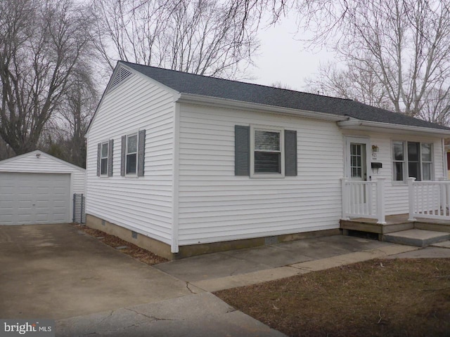 view of front of property with a garage and an outbuilding