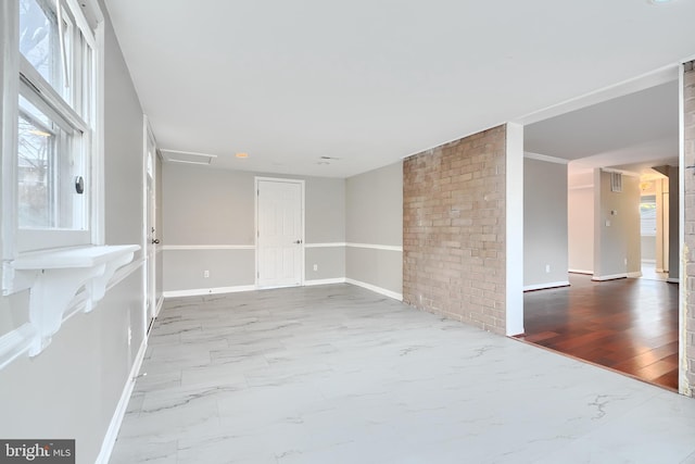 empty room featuring brick wall