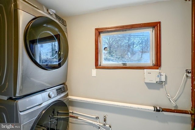 clothes washing area featuring stacked washer / drying machine