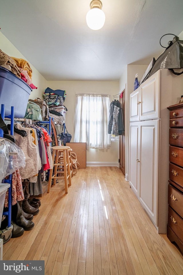 spacious closet featuring light wood-style flooring