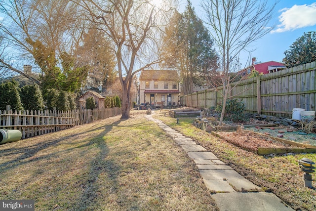 view of yard featuring a fenced backyard and a vegetable garden