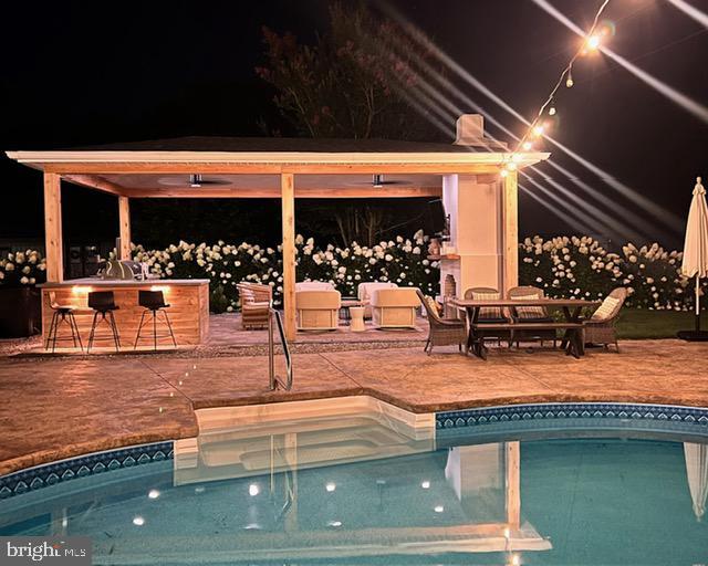 pool at twilight with a jacuzzi