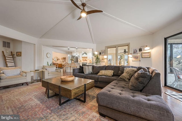 living room featuring high vaulted ceiling, hardwood / wood-style floors, and ceiling fan