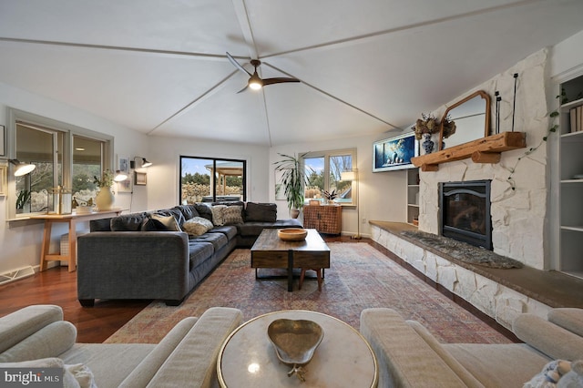 living room with a fireplace, dark hardwood / wood-style floors, and lofted ceiling