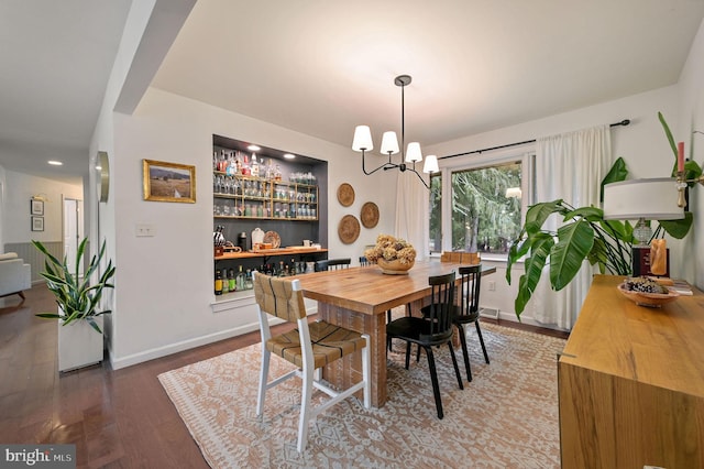 dining space featuring an inviting chandelier and hardwood / wood-style floors