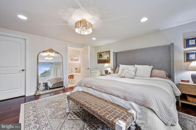 bedroom featuring dark wood-type flooring and ensuite bath