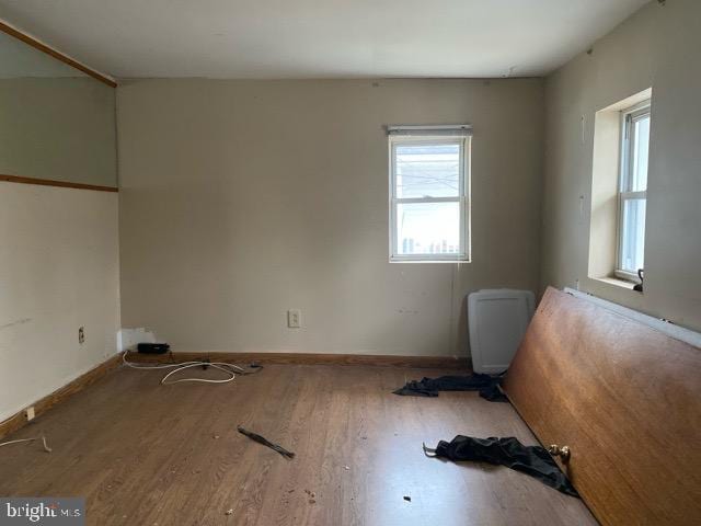 empty room with hardwood / wood-style flooring